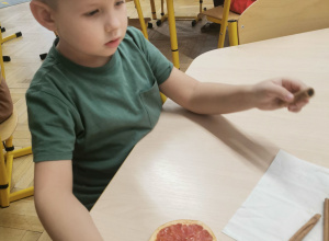 dziecko wykonuje ozdobę na choinkę