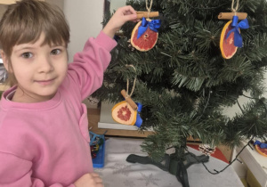 dziecko ubiera choinkę