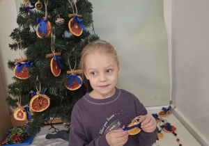dziecko ubiera choinkę