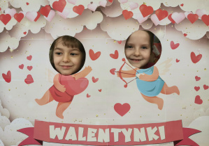 dwoje dzieci w fotobudce, dwa amorki w tle, napis walentynki 8