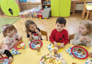 Dzieci biorą udział w urodzinowym poczęstunku.