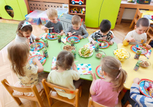 Dzieci biorą udział w urodzinowym poczęstunku.
