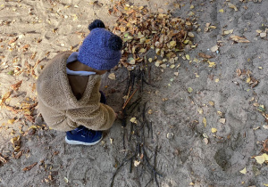 dziecko układa drzewo z patyczków