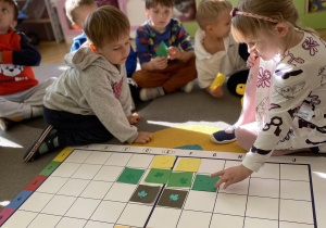 dzieci układają kwadraty na planszy